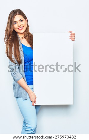 Woman holding white blank signboard. Smiling female model against white studio background.