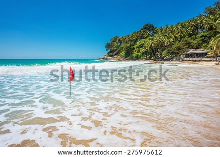 Red warning flag at beach. Phuket, Thailand. 