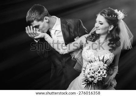 Bride and groom kissing and hugging. wedding photo taken in the studio on a black background.