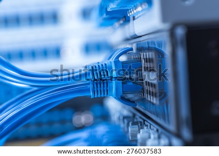 Network switch and ethernet cables,Data Center Concept. Royalty-Free Stock Photo #276037583