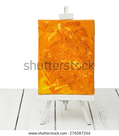 Small miniature easel with canvas with acrylic painted brushstrokes 