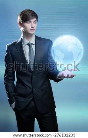 Businessman holding hologram of the earth in his hand