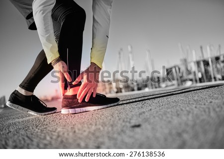 Broken twisted ankle - running sport injury. Athletic man runner touching foot in pain due to sprained ankle.
 Royalty-Free Stock Photo #276138536