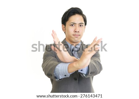Asian businessman making X sign on white background 
