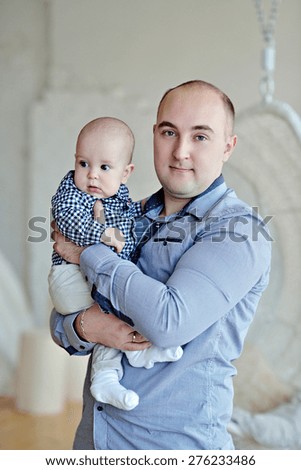 Portrait of the family. Father holding baby