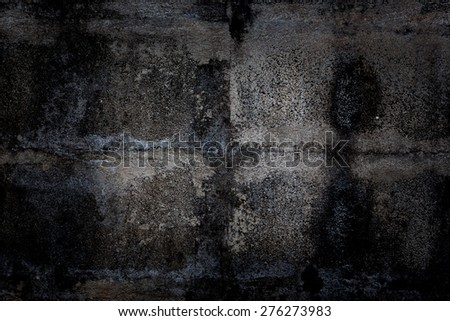 Old dark concrete wall with mould stains as background