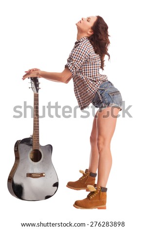 Young beautiful woman with black acoustic guitar over white background 