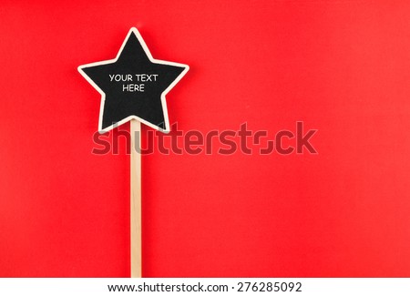 Pointer star  with space for your text, lies on red  background