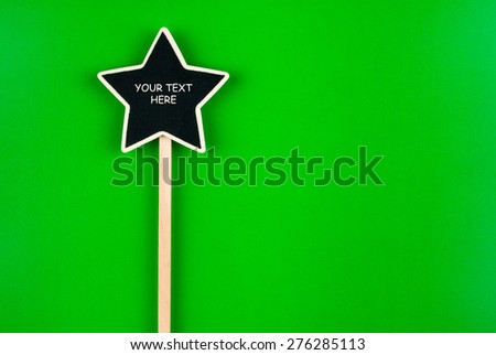 Pointer star  with space for your text, lies on green  background