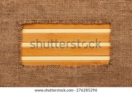 Frame made of burlap lying on a bamboo  mat, with space for your text