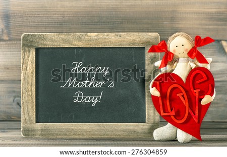 Funny girl with Red Heart and blackboard. Sample text Happy Mother's Day!