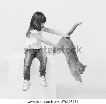 Cute little girl portrait hug red cat smiling jump black and white