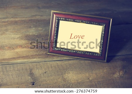 an empty picture frame on a wooden floor