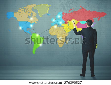 Young businessman drawing map on wall, social network concept
