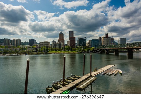 Dock in the Williamette River and the Portland skyline, seen from the Eastbank Esplanade in Portland, Oregon.