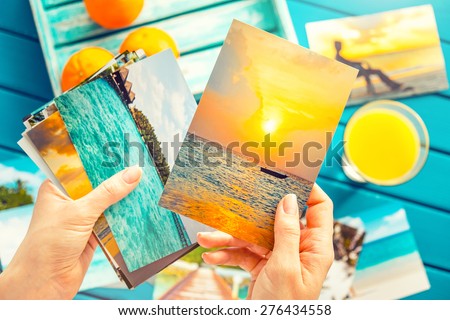 Woman looking at photos in her hands. Top view.