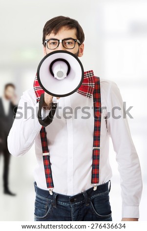 Funny man wearing suspenders shouting with megaphone.