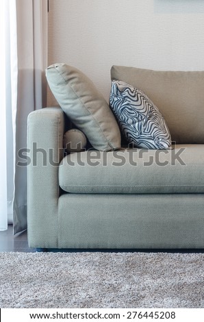 green fabric sofa with black and white pillow in living room
