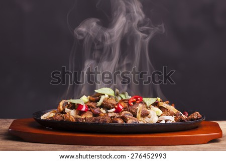 steaming chicken sizzler with noodles  Royalty-Free Stock Photo #276452993