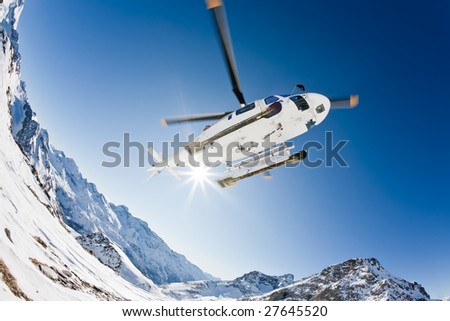 Heli Skiing Helicopter is landing on a ski slope in Gressoney Ski Resort, Aosta, Italy. Royalty-Free Stock Photo #27645520