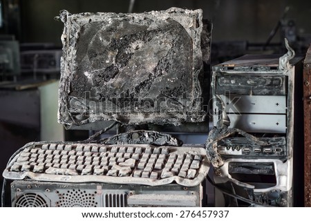 Personal computer burnt due to electricity short circuit - Threat to computer hardware concept Royalty-Free Stock Photo #276457937