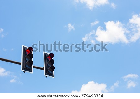 Traffic lights on blue sky background.