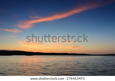 Small wooden pier on big lake at sunset in Ukraine
