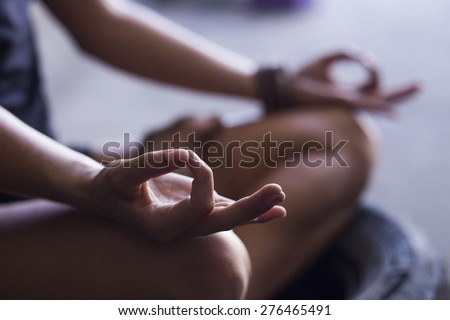Young woman meditating indoors Royalty-Free Stock Photo #276465491