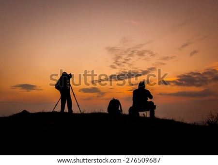 Silhouette of photographers with beautiful sky