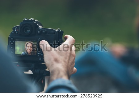 Photographer shooting hands close up and model posing on background