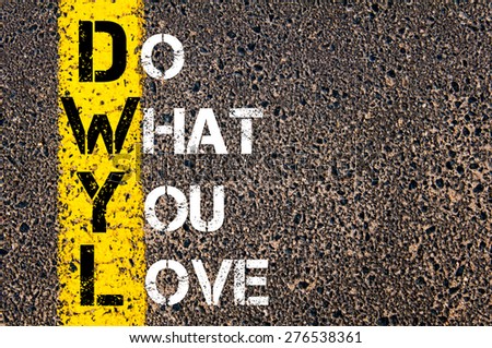Do What You Love motivational quote. Yellow paint line on the road against asphalt background. Concept image