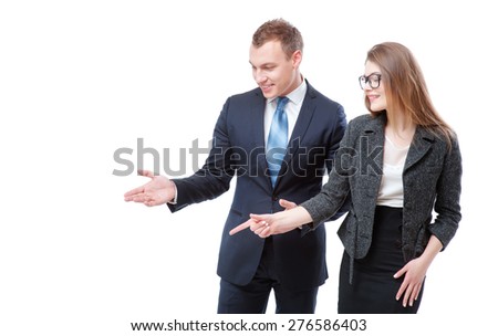 Advertising your product. Happy young couple businessman and businesswoman pointing copy space and smiling while standing isolated on white.