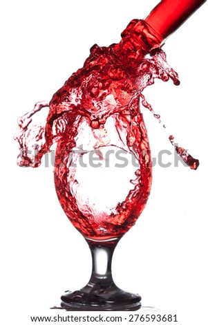 Splash of wine in the cup filling on a white background