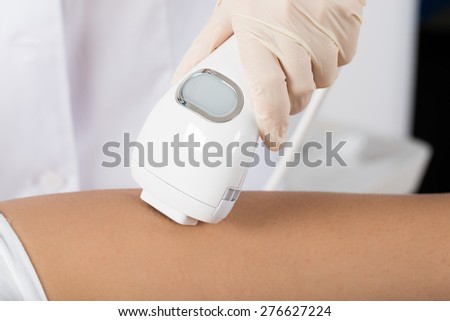 Close-up Of Beautician Giving Epilation Laser Treatment On Woman's Leg Royalty-Free Stock Photo #276627224
