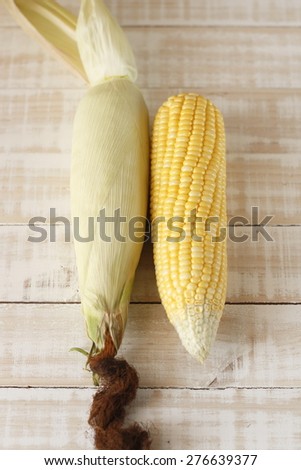 fresh corn on wooden background, raw corn