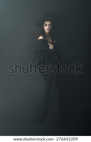 slender witch in a dark fog is beautiful