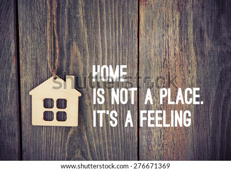 house as symbol on wooden background with quote