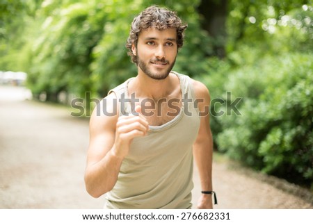 Couple running in a park. Shallow depth of field, focus on the woman