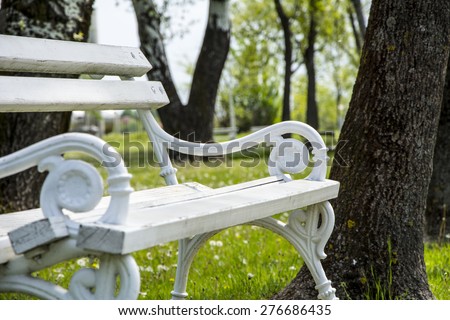 Iron bench in a city park Palic. White iron bench photographed in city park Palic, Serbia. Still in usable condition. Picture taken on nice sunny day
