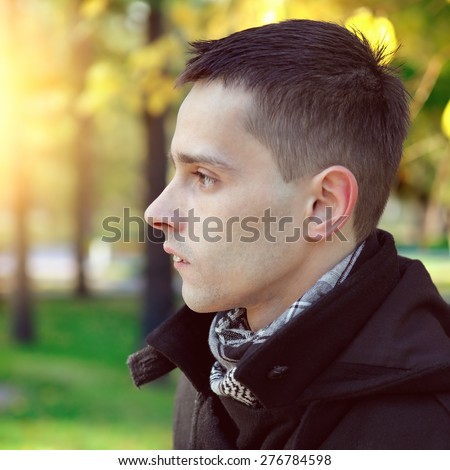 Toned Photo of Portrait of the Serious Man at the Autumn Park