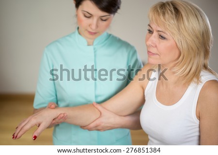 Adult woman during rehabilitation in physiotherapist's office Royalty-Free Stock Photo #276851384