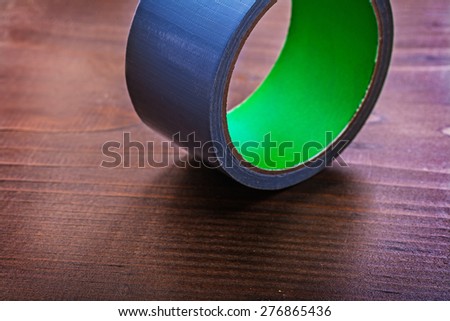 Duct tape on vintage brown wooden board construction concept 