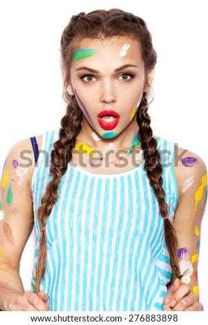Young cheerful soiled in paint girl having fun. Woman with bright makeup and hairstyle with pigtails. White background not isolated