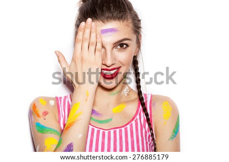 Young cheerful soiled in paint girl having fun. Smiling Woman with bright makeup and hairstyle with pigtails. White background not isolated