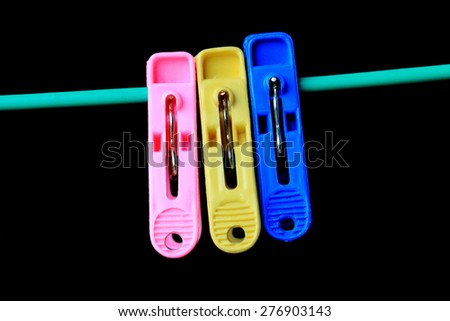 Clothes peg in the black background,black,shallow depth of field