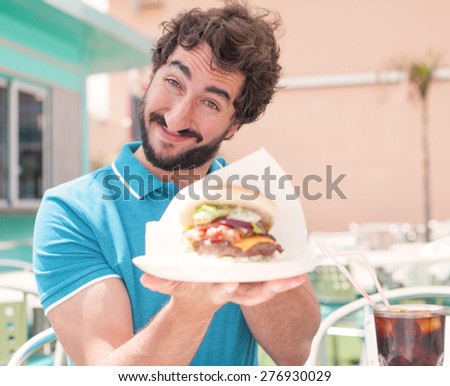 young man offering a burger