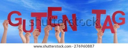 Many Caucasian People And Hands Holding Red Letters Or Characters Building The German Word Guten Tag Which Means Good Day On Blue Sky