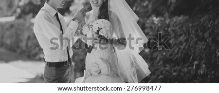 Happy bridal couple in forest. Summer wedding picture in black and white. 