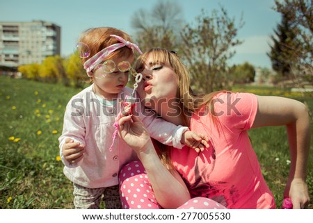 Beautiful Mother And Baby Outdoors. Nature
