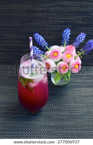 Chilled Red Grape Juice with Mint and Soda on Black Background, Decorated with Flowers